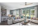 Spacious living room with comfy sofas, large windows, and a view of the backyard at 622 Red Monarch Way, Moncks Corner, SC 29461