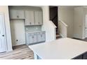 Gray cabinets and quartz countertops. Kitchen island and hardwood floors at 768 Blueway Ave, Summerville, SC 29486