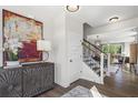 Elegant entryway with statement art, wood-toned cabinet, and hardwood floor at 2800 Seaton Street, Summerville, SC 29486