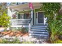 Inviting front porch with hanging plants and seating at 794 Hunt Club Run, Charleston, SC 29414