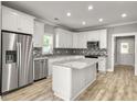 Modern kitchen with stainless steel appliances and granite island at 4566 Durant Ave, North Charleston, SC 29405