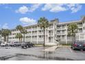 Multi-story building with ample parking and palm trees at 93 Mariners Cay Drive, Folly Beach, SC 29439