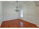 Formal dining room with hardwood floors, chandelier, and wainscoting at 106 Aviary Ct, Summerville, SC 29483