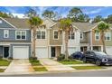 Two story townhomes with attached garages and palm trees at 171 Rosefield Ct, Summerville, SC 29485