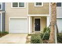 Modern townhouse exterior with a white garage door and black front door at 171 Rosefield Ct, Summerville, SC 29485