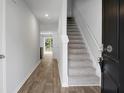 Light and airy entryway with wood-look floors and staircase at 171 Rosefield Ct, Summerville, SC 29485