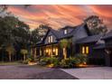 Two-story home with modern farmhouse exterior, charming porch and landscaping at 4028 Gnarled Oaks Ln, Johns Island, SC 29455