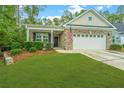 Attractive brick home with a two-car garage and manicured lawn at 220 Brutus Ln, Summerville, SC 29485