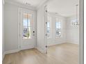 Bright entryway with white door and view into dining room at 501 Eagle View Dr, Moncks Corner, SC 29461