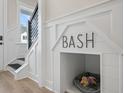 Built-in dog house niche in entryway with modern staircase and wood floors at 345 Bremerton Dr, Goose Creek, SC 29445
