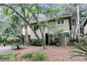 Exterior view of a charming two-story house with lush landscaping at 1111 Summerwind Lane, Seabrook Island, SC 29455