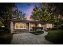 Brick ranch home with a covered porch and well-maintained landscaping at sunset at 101 Robin Ct, Summerville, SC 29485