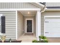 Front entry with a covered porch and black front door at 1241 Locals St, Summerville, SC 29485