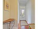 Light-filled entryway with hardwood floors and small table at 204 Michigan Ave # D2, Folly Beach, SC 29439