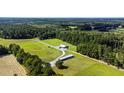 Aerial view of a property with farm buildings and open fields at 0 Tuten Road, Round O, SC 29474