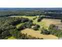 Aerial view of a farmhouse nestled in vast farmland at 0 Tuten Road, Round O, SC 29474