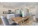 Open concept dining room with kitchen and hardwood floors at 205 Torslanda Ln, Summerville, SC 29486