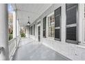 Spacious front porch with white columns and black shutters at 52 Hasell St, Charleston, SC 29401