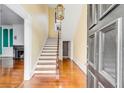 Bright entryway with hardwood floors and a grand staircase at 52 Hasell St, Charleston, SC 29401