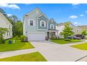 Two-story light teal house with white accents and landscaping at 180 Cherry Grove Dr, Summerville, SC 29483
