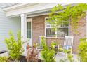 Front porch with brick columns and rocking chairs at 180 Cherry Grove Dr, Summerville, SC 29483