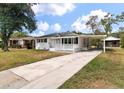 One story house with a carport and landscaped yard at 7049 Kenneth Dr, North Charleston, SC 29406