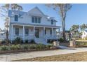 White farmhouse with wrap around porch at 3881 Summerton St, Mount Pleasant, SC 29466
