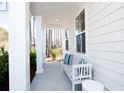 Relaxing front porch with white bench and pillows at 123 Cantona Dr, Summerville, SC 29483