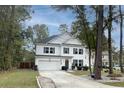 Two-story home with white siding, a gray door, and a two-car garage at 154 Pecan Dr, Summerville, SC 29483