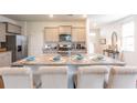 Kitchen island with seating for four, granite countertop and stainless steel sink at 190 E Pinckney St, Lincolnville, SC 29485