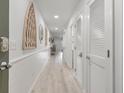 Bright hallway with white shiplap walls and light wood floors at 1331 Pelican Watch Villas, Seabrook Island, SC 29455