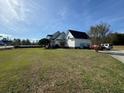 White two story home with attached garage and large yard at 204 Charles St, Saint George, SC 29477