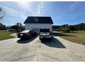 Detached garage with two cars parked in the driveway at 204 Charles St, Saint George, SC 29477