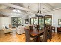 Open concept dining room with hardwood floors and a chandelier adjacent to the living room at 362 Pelican Flight Dr, Dewees Island, SC 29451