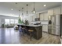 Modern kitchen with granite island, stainless steel appliances, and hardwood floors at 415 Snowy Plover Ln, Summerville, SC 29486