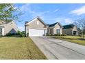 Tan house with white garage door and driveway at 510 Eastern Isle Ave, Summerville, SC 29486