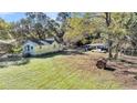 Aerial view of a yellow house with a large yard and detached garage at 1860/1858 Taberwood Cir, Charleston, SC 29407