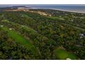 Aerial view showcasing a golf course community near the ocean at 2588 High Hammock Rd, Johns Island, SC 29455