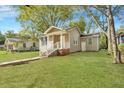 Tan bungalow with a walkway and landscaping at 2674 Houston St, North Charleston, SC 29405