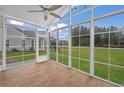 Bright sunroom with wood tile flooring and ample windows offering backyard views at 126 Harbor Trace Ln, Summerville, SC 29486