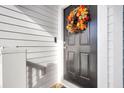 Black front door adorned with a fall-themed wreath at 681 Mclernon Trce, Johns Island, SC 29455