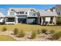 House exterior showcasing a large backyard with a patio and landscaping at 3811 Sawyers Island Dr, Mount Pleasant, SC 29466
