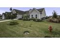 Gray two-story home with front porch and landscaped yard at 119 Camelia Park Ln, Summerville, SC 29486