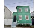 Quaint green house with white trim, steps, and small porch at 2 Ducs Ct, Charleston, SC 29403