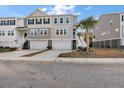 Three story townhome with attached garage and front yard at 139 Winding River Dr, Johns Island, SC 29455