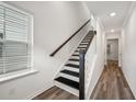 Modern staircase with dark wood railings and black risers, leading to upper floors at 1830 Helm Ave, North Charleston, SC 29405