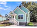 Charming light green house with white trim and a front porch at 2711 Henry St, North Charleston, SC 29405