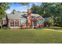 Brick house with blue shutters and a landscaped yard at 112 Minus St, Saint George, SC 29477