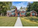Charming brick home with blue shutters and a walkway at 112 Minus St, Saint George, SC 29477