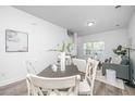 Dining area with a farmhouse table and chairs, adjacent to the living room at 104 Aplomb Aly # 16, Charleston, SC 29414